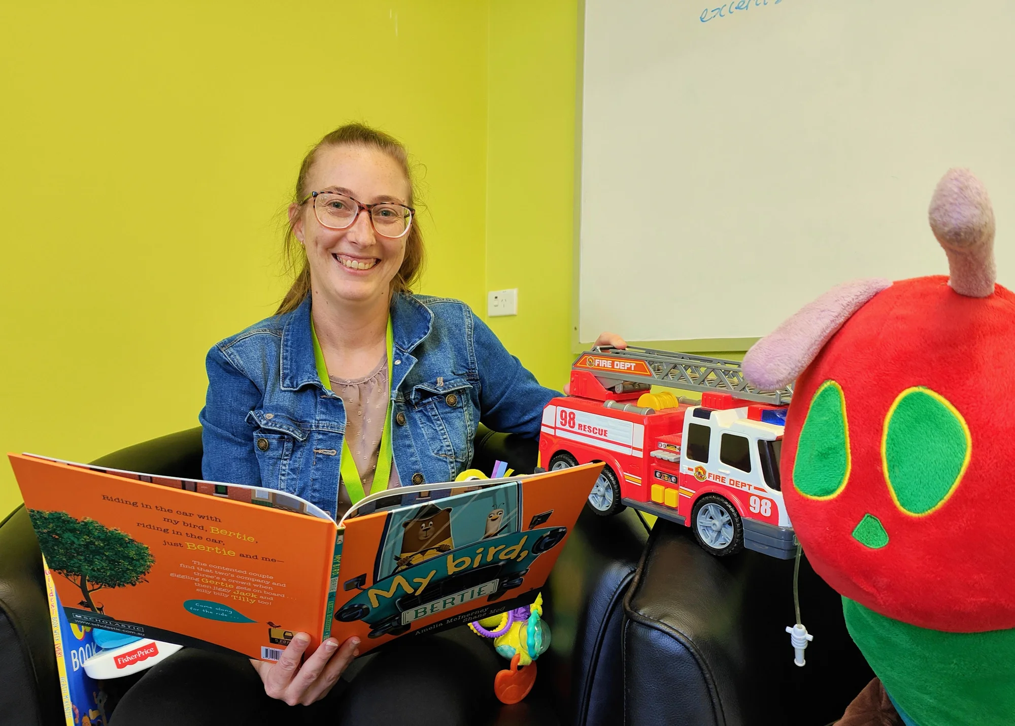 Smalltalk playgroup teacher with book and toys